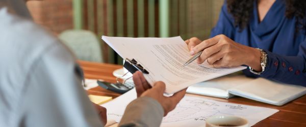 Businessman consulting with lawyer before signing contract